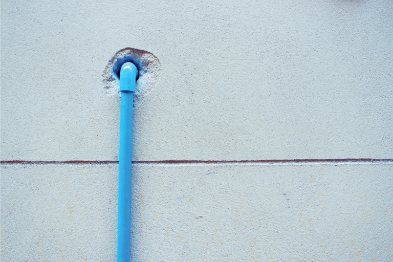 blue-pvc-pipe-on-a-white-wall.-Water-Pipe-Sticking-Out-Of-Wall---Can-I-Remove-It-Or-Cover-It