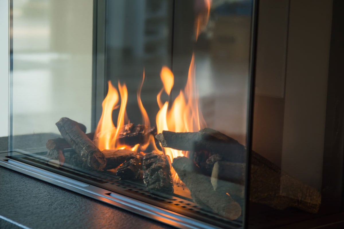 fire burns glass fireplace radiates heat
