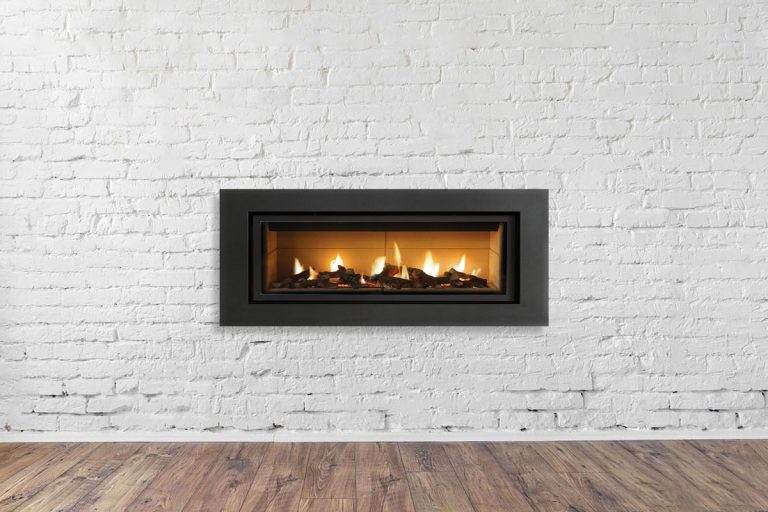 photo of a gas-fireplace-on-white-brick-wall-1249350982, Why Doesn't My Gas Fireplace Light After Summer?