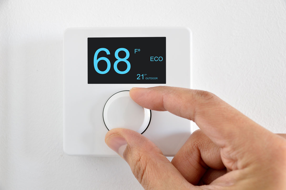 hands Digital thermostat on the wall