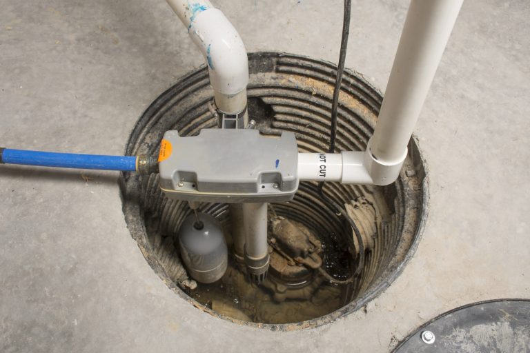 A sump pump installed in a basement of a home with a water powered backup system - My Sump Pump Float Switch Is Stuck On - What To Do?