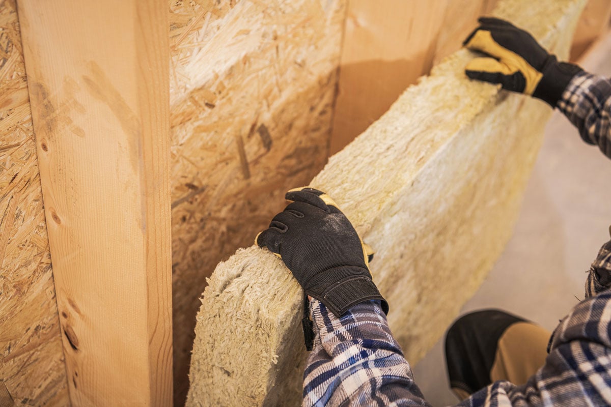 Construction Worker Insulating House Walls with Thermal Material