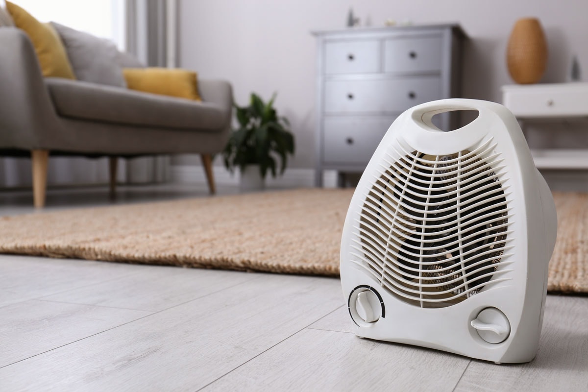 Electric heater fan on living room placed near the carpet