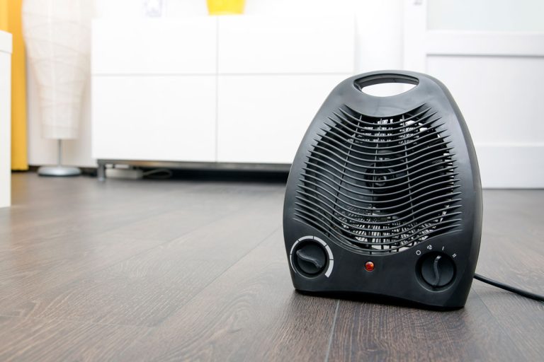 Electric heater on laminate floor in the room, Should A Fan Heater Spark? [Here's What You Need To Know!]