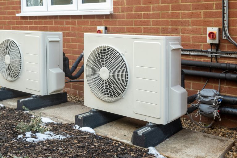 Two air source heat pump units installed on a modern house, Heat Pump Reaches Temp But Keeps Running - Why and What To Do