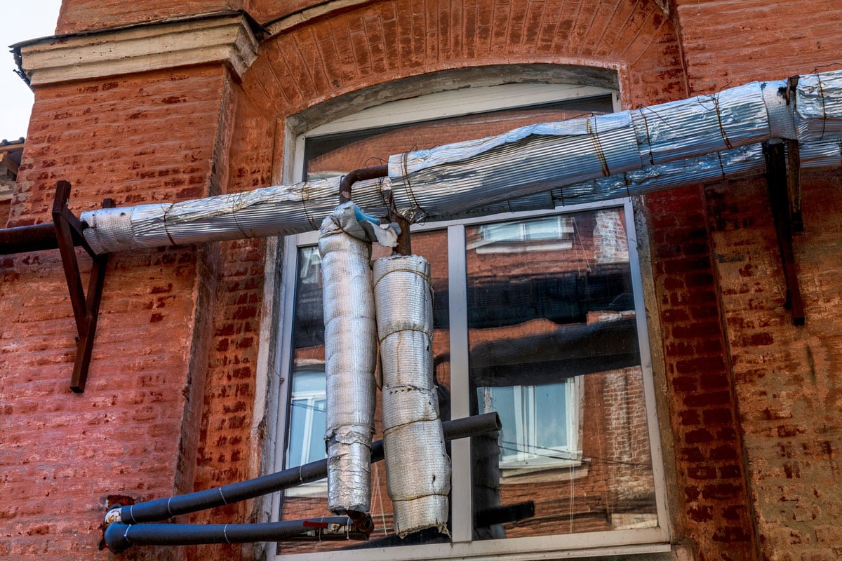 Heating pipes on the facade of a residential building