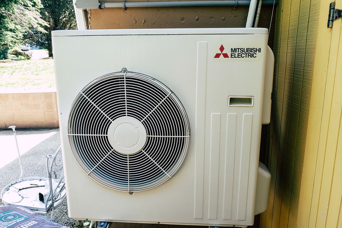Mitsubishi ductless mini split system being inspected for summer air conditioning operation