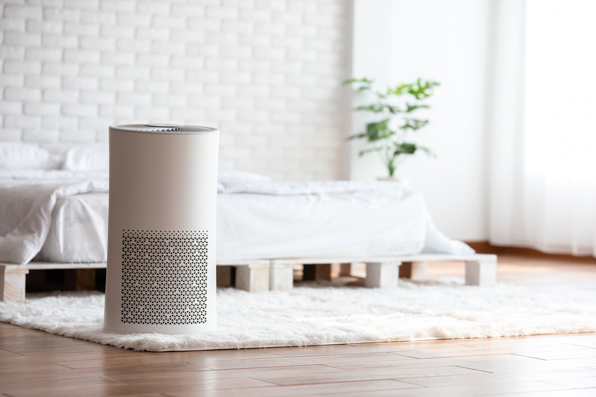 Modern air purifier in the bedroom by the bed