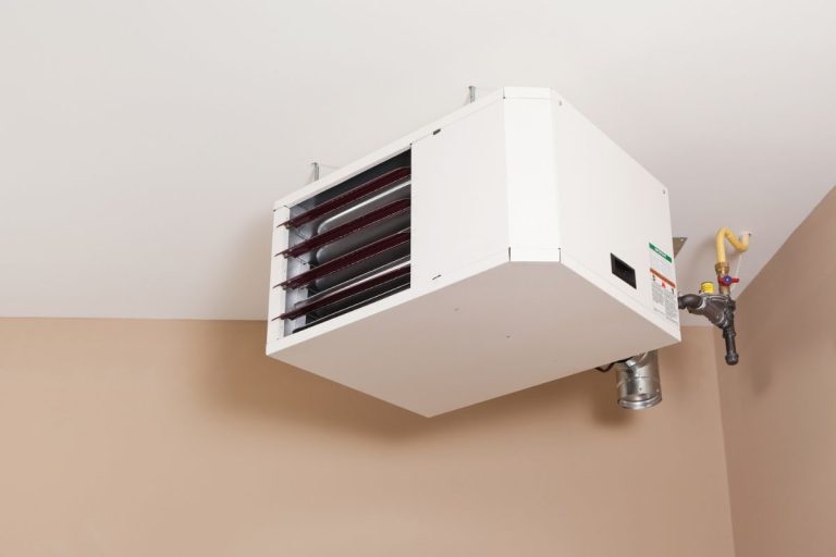 A big heavy industrial electric fan heater in double car garage interior, How To Install King Electric Garage Heater [Step By Step Guide]