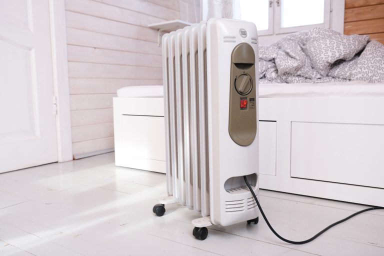 An oil-filled electrical mobile radiator heater for home heating and comfort control in the room in a wooden country house, Should I Use A Fan With My Oil Heater?