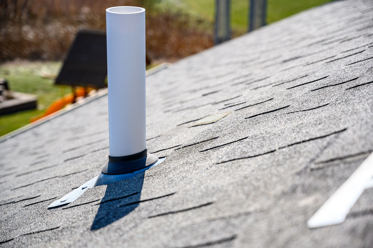PVC chimney exhaust with boot on asphalt roof