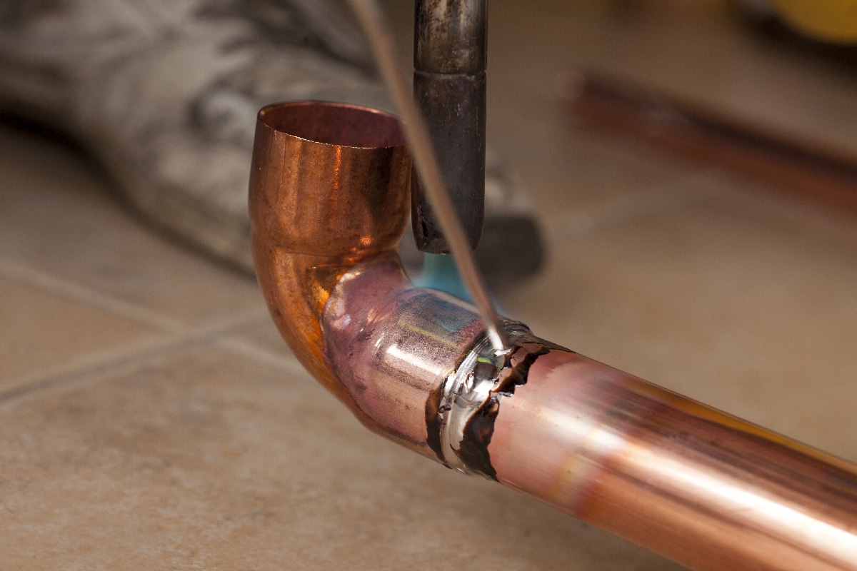 Soldering copper pipes with tin and torch