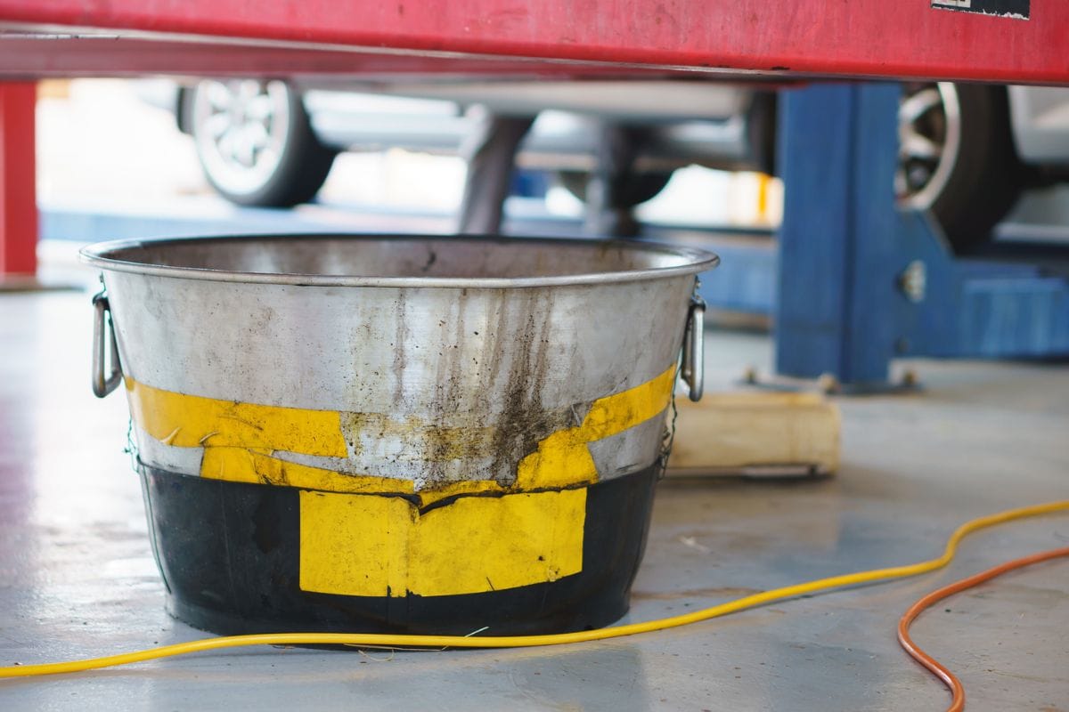 Steel bucket use for store old engine or mechanic oil from a car for change at an auto shop