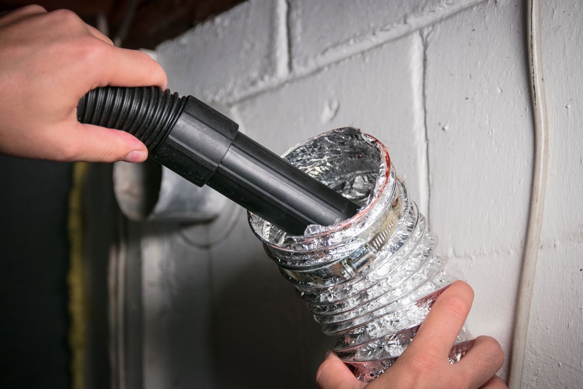 Vacuum cleaning a flexible aluminum dryer vent hose, to remove lint and prevent fire hazard