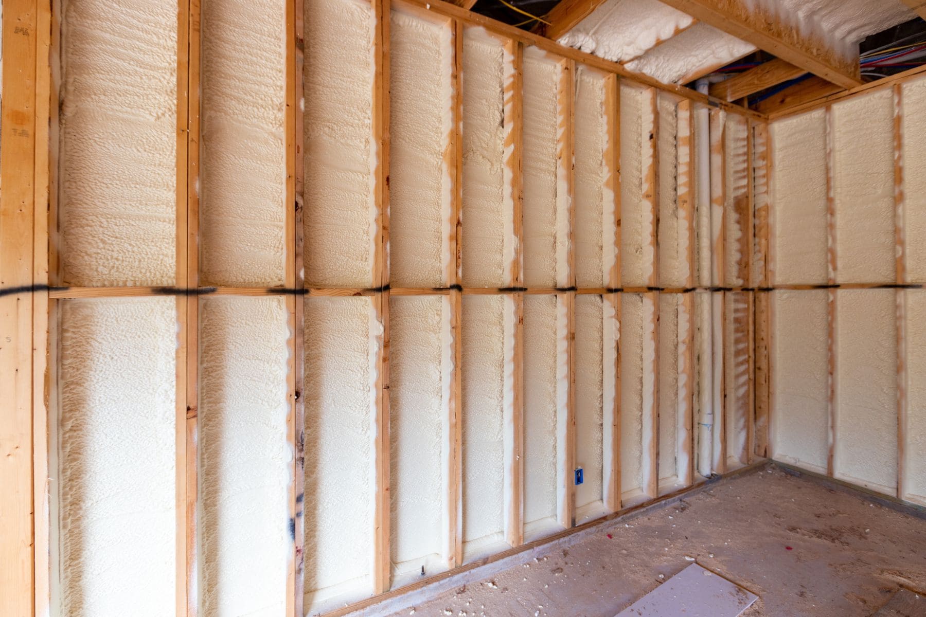 Wall in new home under construction, with spray foam insulation
