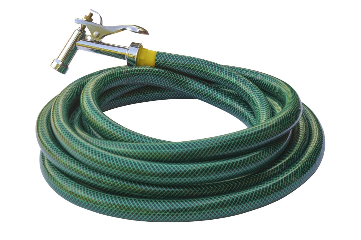 Water taps and green garden hose with a sprayer