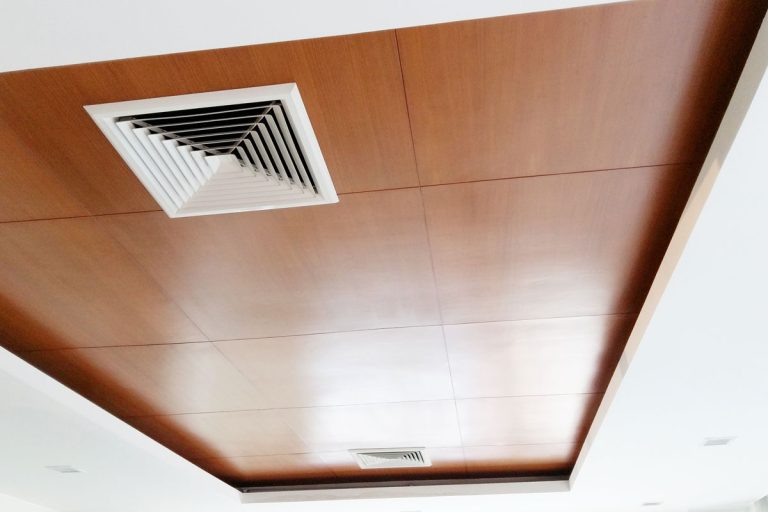 White color square air vent on brown wood ceiling, How To Secure A Ceiling Vent Without Screws [Options & Troubleshooting Tips]