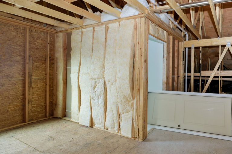 Wooden roof beams with insulates the attic with mineral wool and pipe heating system. - Spray Foam For Basement Walls: Pros And Cons?