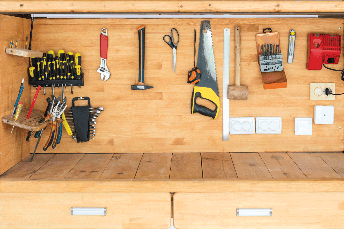 Wooden workbench at workshop. Lot of different tools for diy and repair works.
