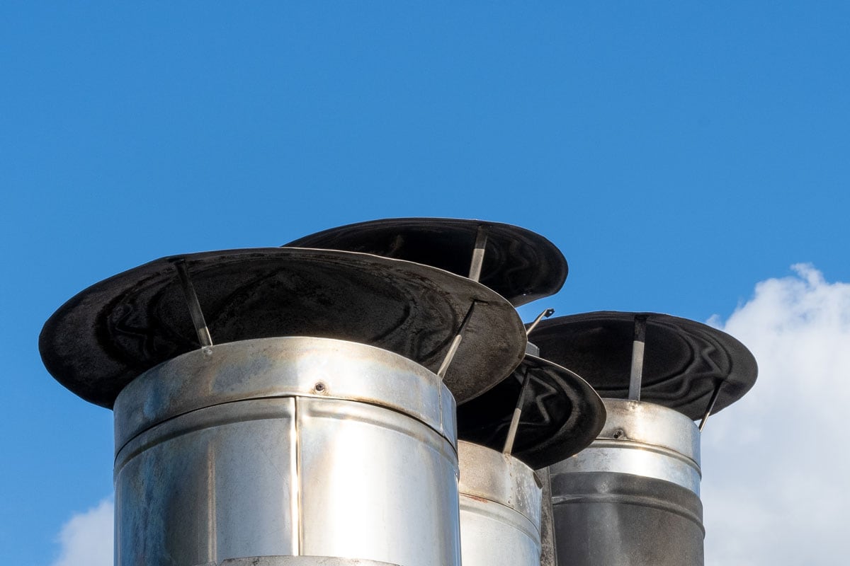 a Galvanized metal chimneys exhaust with a rain cap