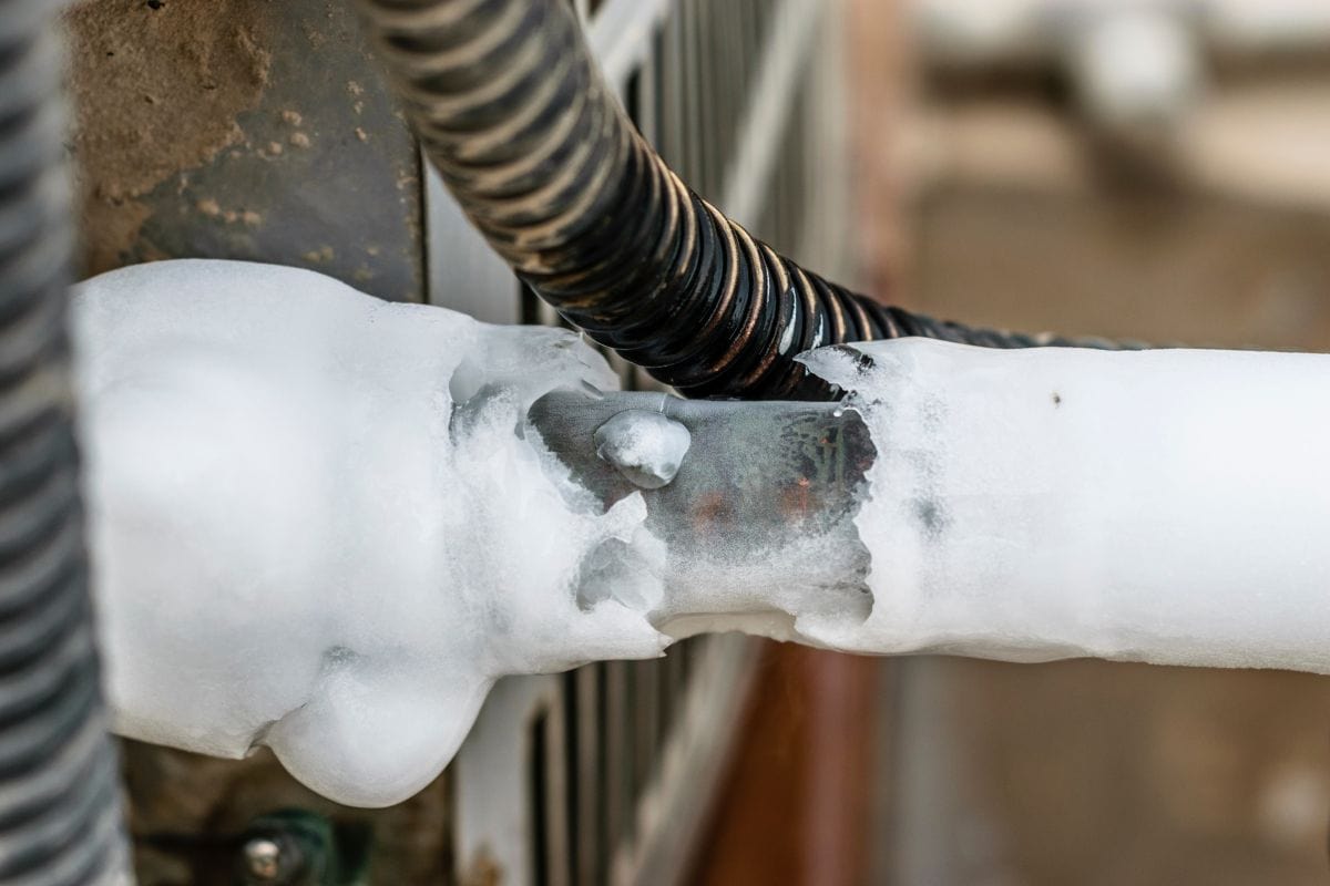 ac cooling air pipes covered by snow or frozen because of super performance of heavy duty central air conditioning system on the roof top in hot summer days