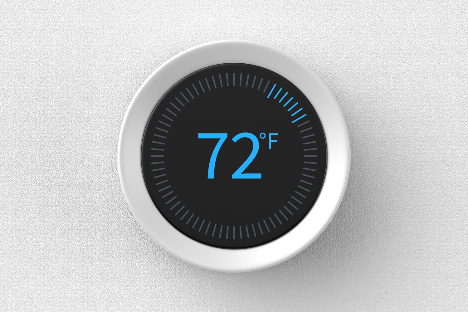 Smart thermostat showing the temperature in Fahrenheit mounted on a white wall