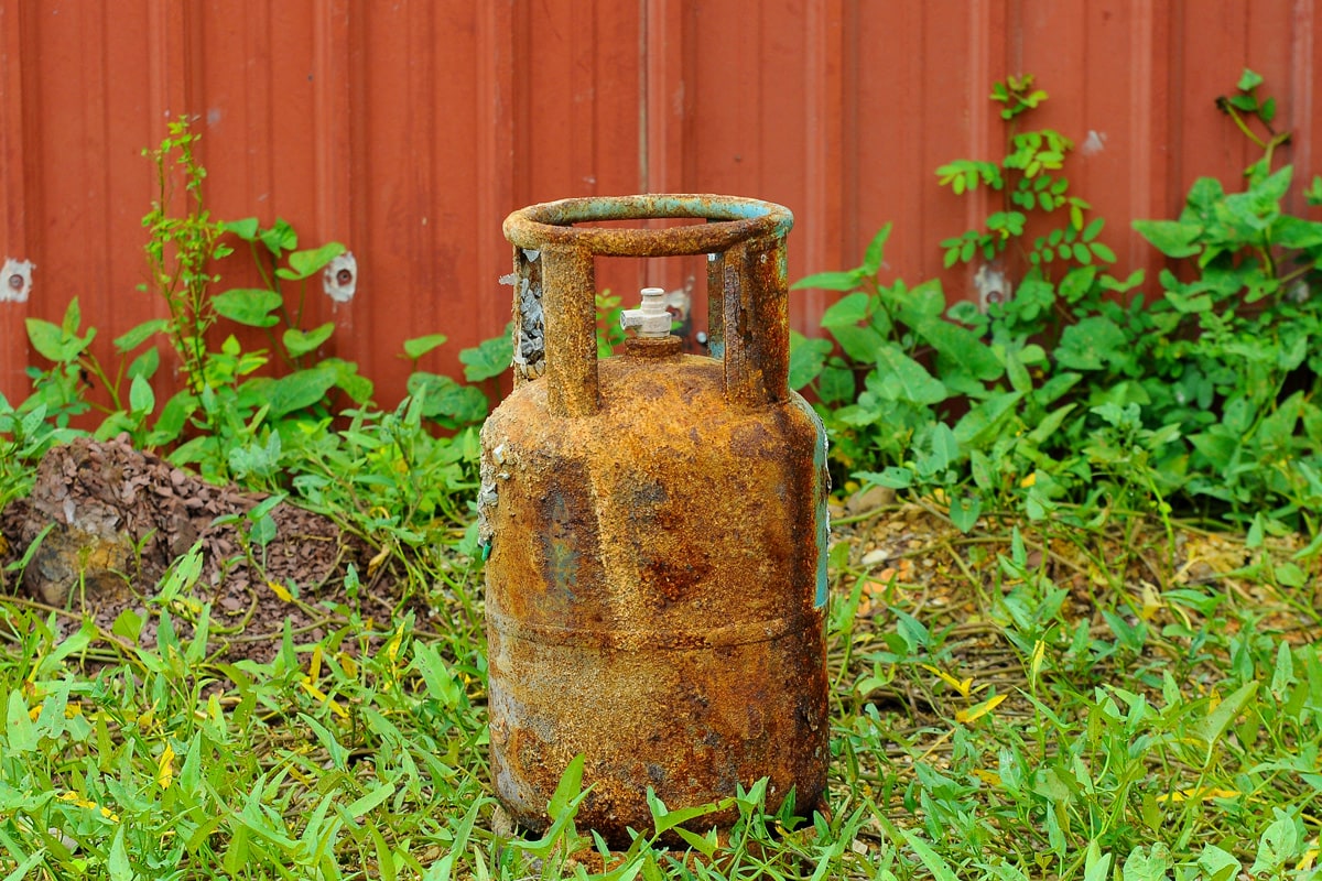 An old and rusted propane tank