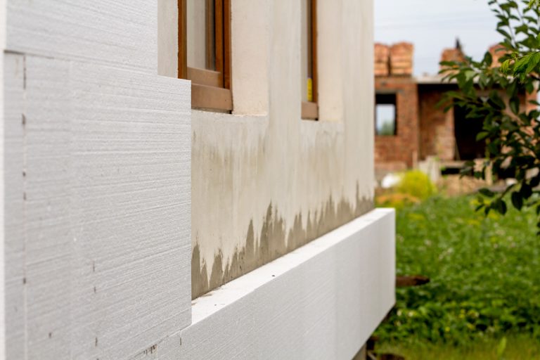 Close-up detail of plastered house wall with rigid styrofoam insulation. Modern technology, construction, renovation, energy saving, alternative for mineral wool, warm comfortable house concept., Does Rigid Foam Insulation Need To Be Covered?