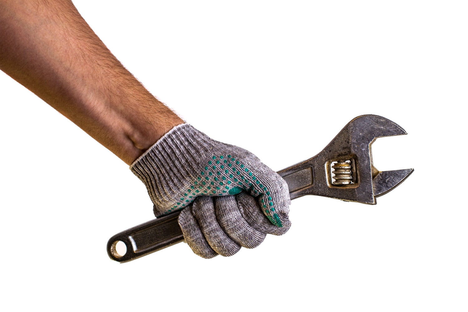 Close up view of a man's hand holding adjustable wrench isolated on white background. Mechanic and repairman. Handyman. DIY concept. Tools and instruments. 