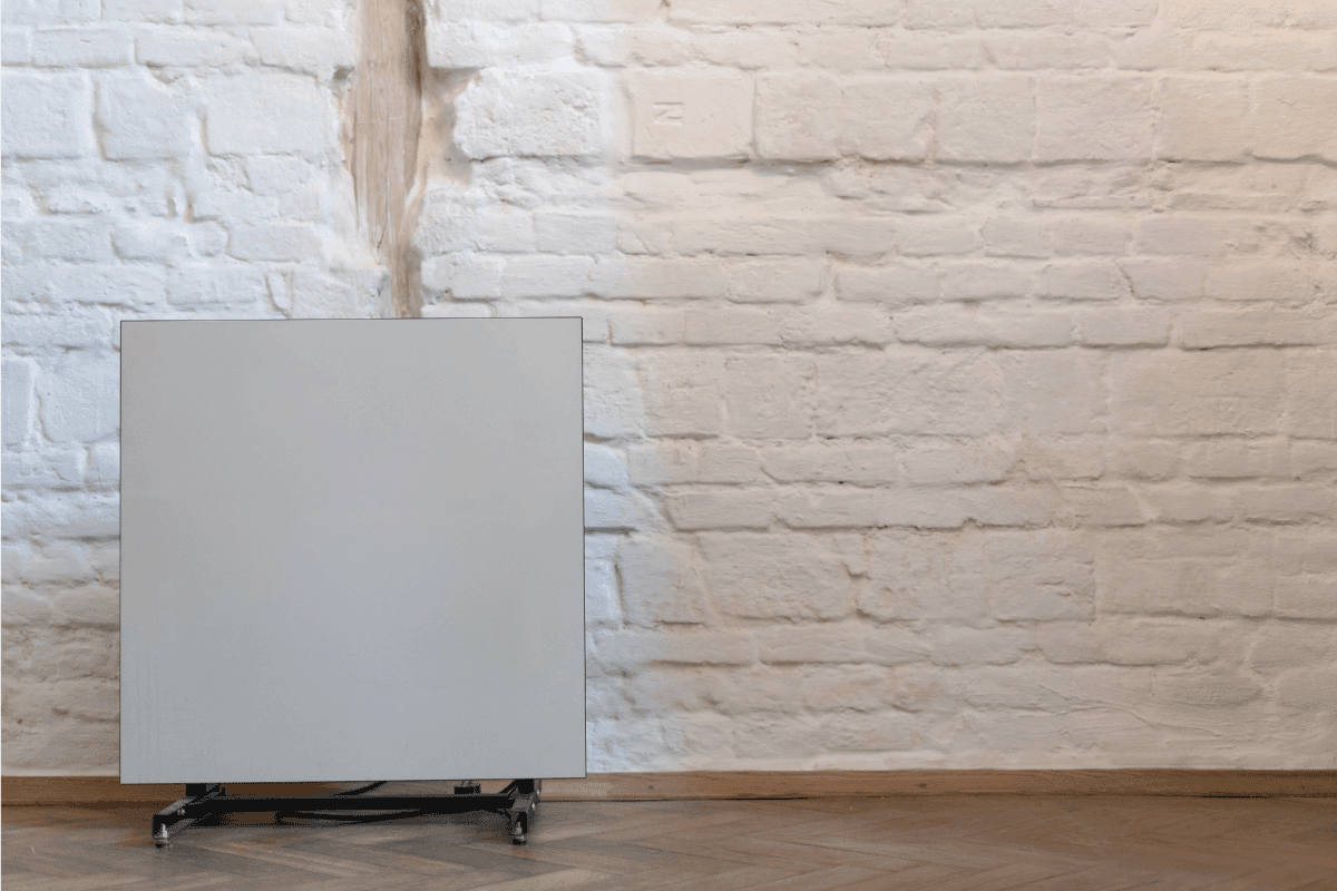Heater near white brick wall. Contemporary electric radiator in cozy house