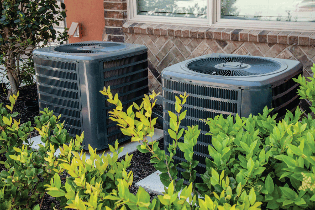 Heating and air conditioning units on the side of a brick building 