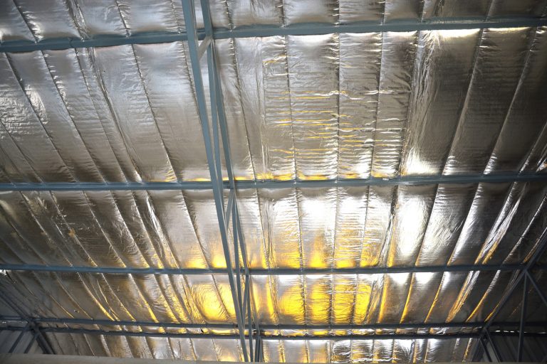 Insulation sheet placed under metal frame roof for heat protection - How To Install Double Bubble Insulation In A Metal Building