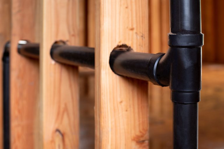 close on abs t joint pipes black colored pipe through the wood, Types Of Vents In Plumbing: Comprehensive List