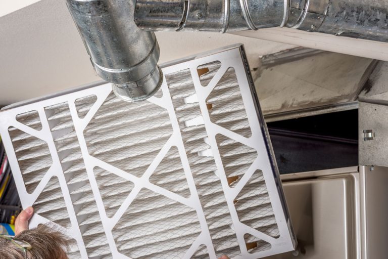 handyman inspects filter home furnace, How To Keep Your Furnace Filter In Place