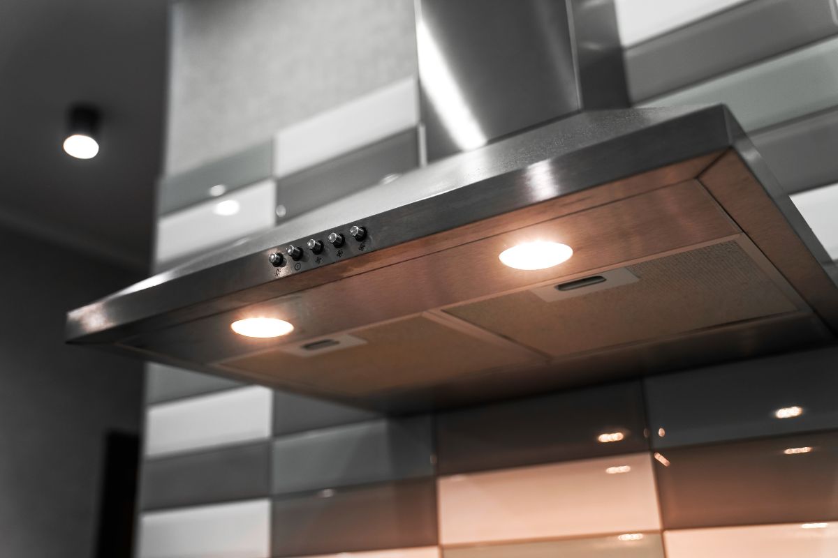 kitchen metal hood with illumination close-up. extractor hood in the restaurant. electrical equipment for the kitchen