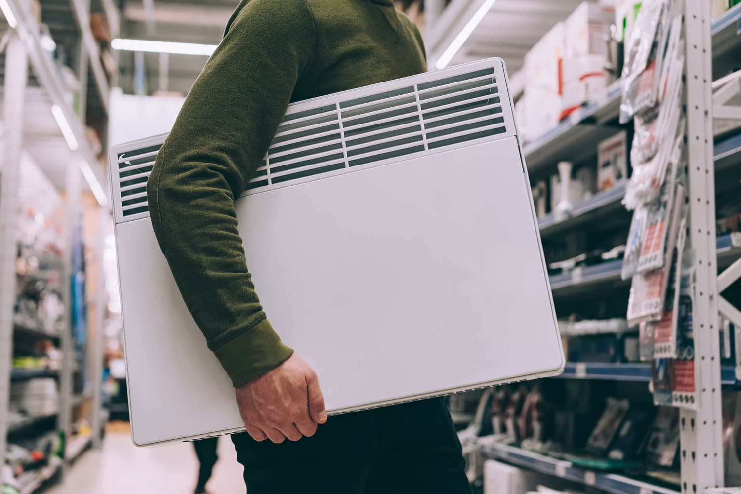 A man chooses a heater in a supermarket 