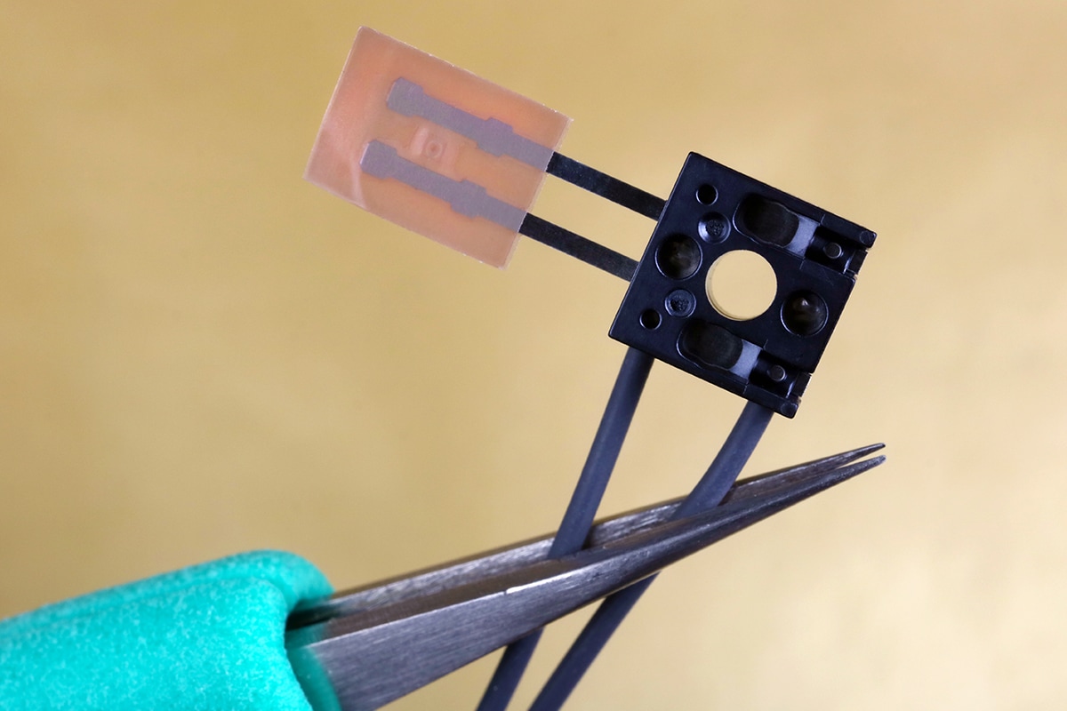 A technician install the new thermistor in modern electronic device