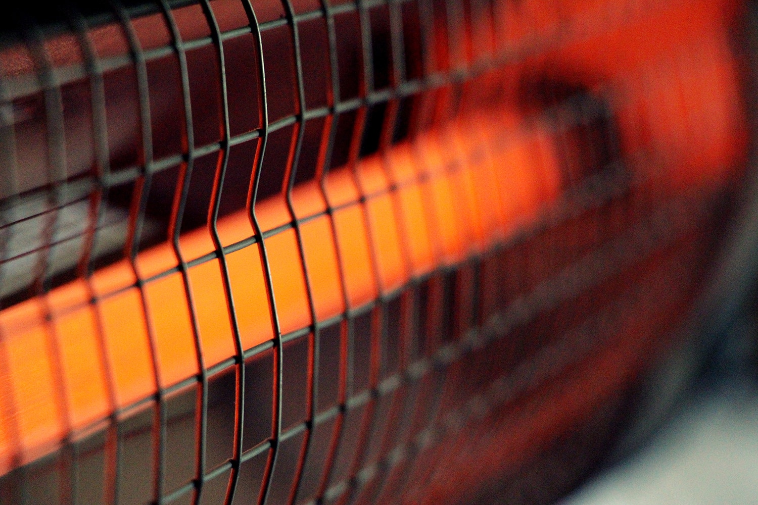 Electric red heater close-up with a metal grill