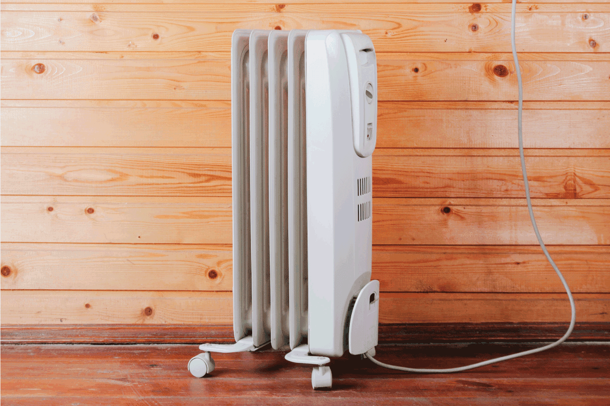 Heater against a wooden wall. How Many Space Heaters Can I Run [Safely]