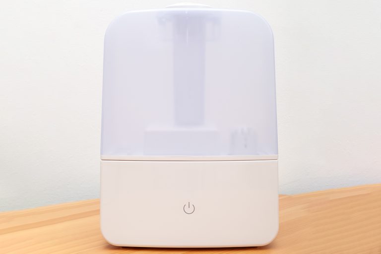 Cool mist humidifier on wooden table, why is my sunbeam cool mist humidifier not working? [& common fixes]