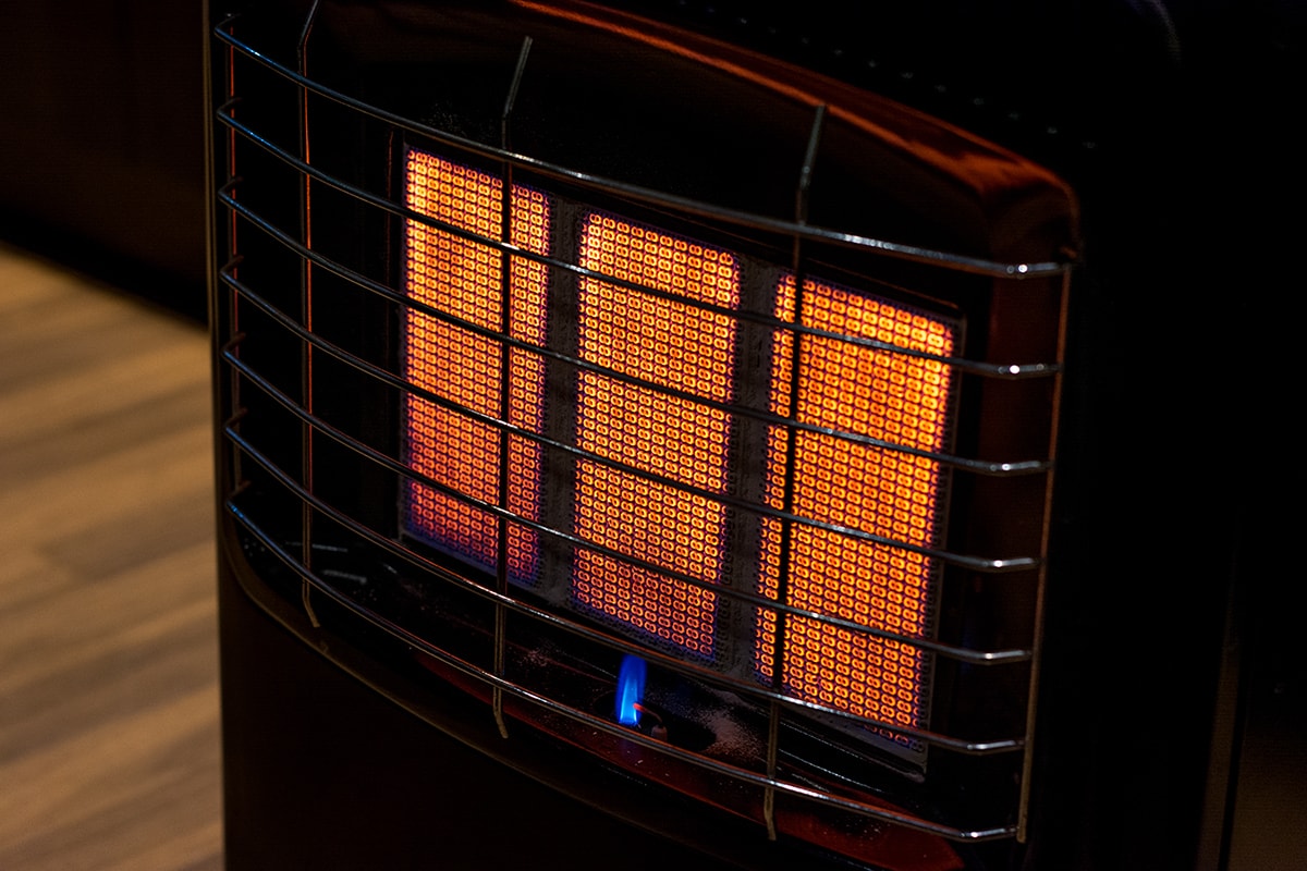 Portable heater glowing orange, burning at full capacity during night time