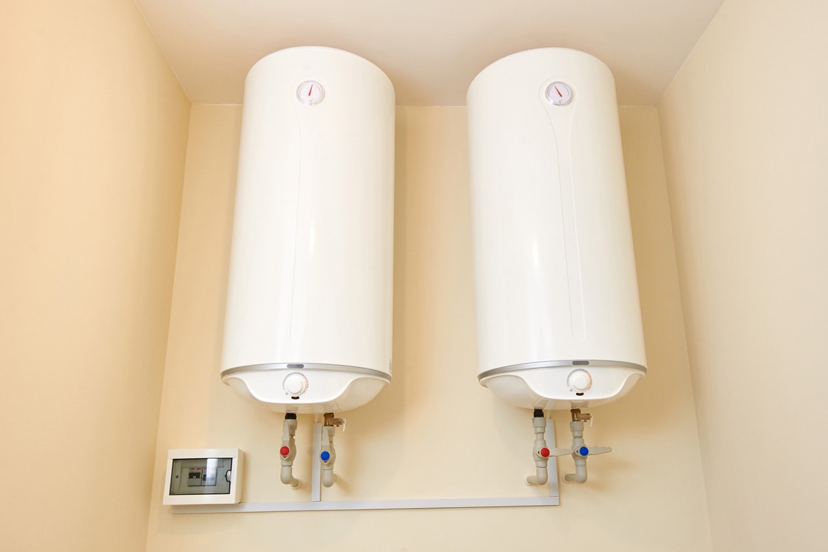 Two electric water heaters on the wall.