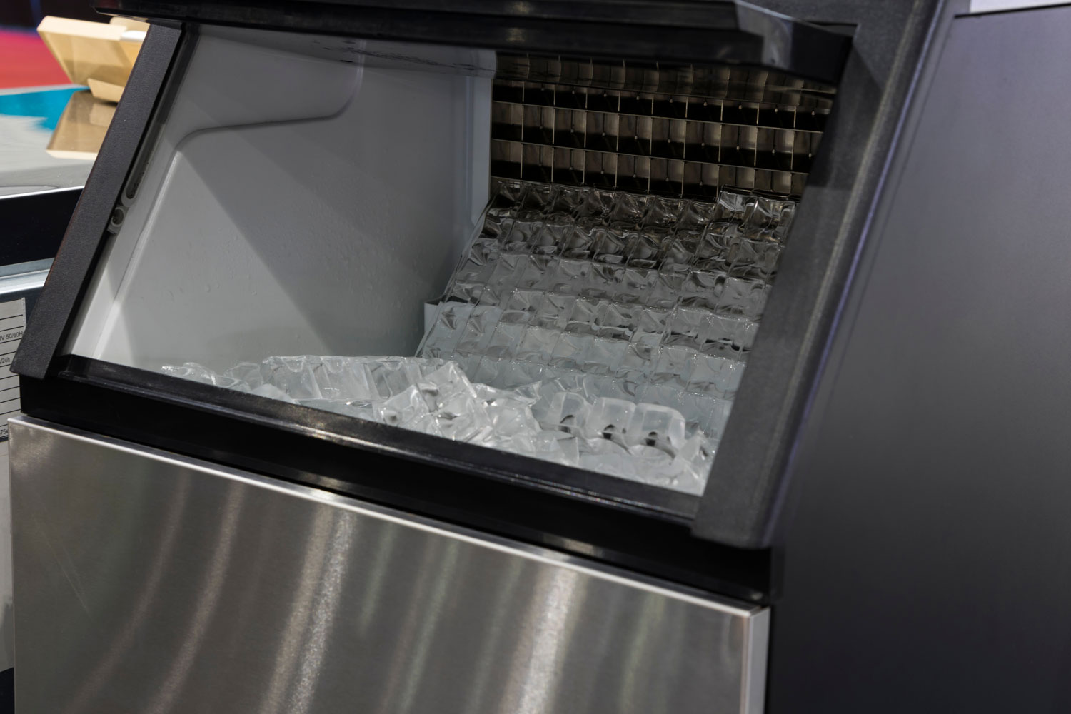 cube ice in ice making machine that door open food industrial background close up
