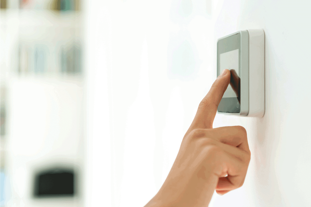 smart house, device with app icons. Man uses his smartphone security app
