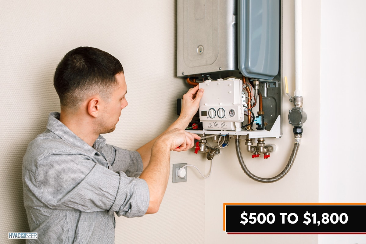 Plumber attaches Trying To Fix the Problem with the Residential Heating Equipment. Repair of a gas boiler, How Much Does It Cost To Repair A Boiler?