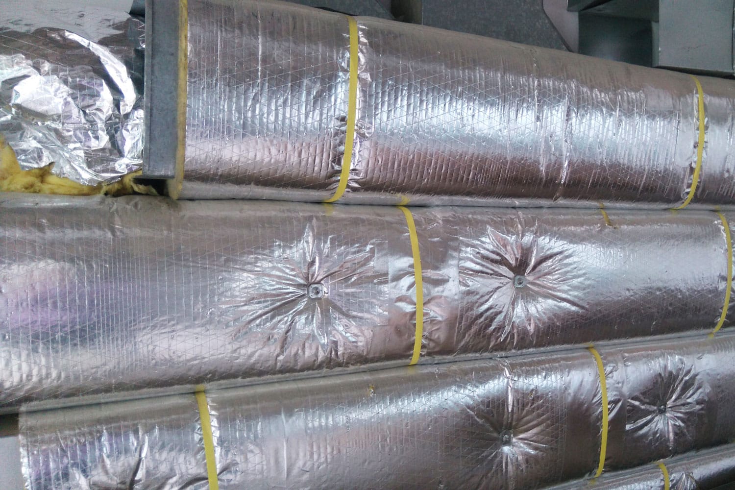 Air condition ducting work for fixing.Insulated duct.HVAC system on a building site.Aluminum fabricated air flow duct. 