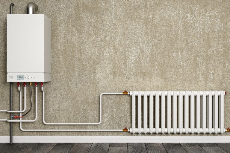 Boiler, water pipes and radiator in front of concrete wall, How To Remove A Radiator On A Combi Boiler System