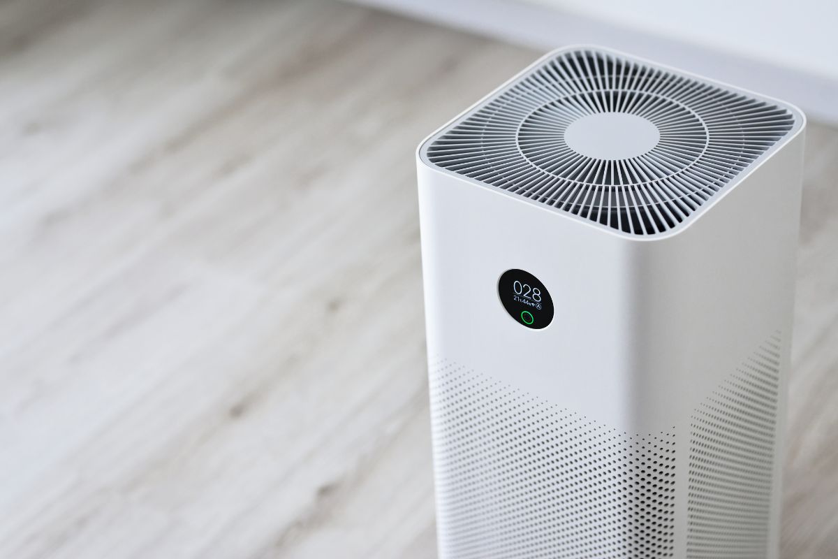 Closeup of an indoor Air purifier in the room is very safe and clean to breathe while dust air pollution situation outside is really bad. protect PM 2.5 dust and air pollution concept. Air purifier.