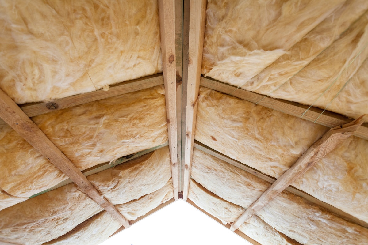 Insulation of attic with fiberglass cold barrier and insulation material