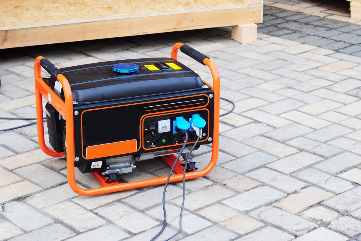 Gasoline Portable Generator on the House Construction Site. Close up on Mobile Backup Generator .Standby Generator - Outdoor Power Equipment 